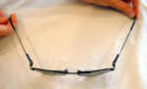 Eyeglasses held by a hand with a blurred background