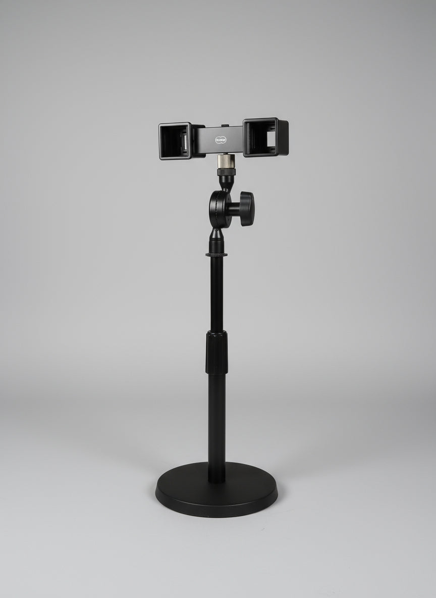 Camera stabilizer attached to a chair with a window and curtain in the background