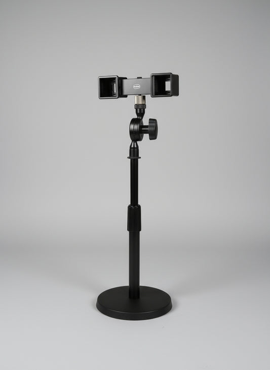 Camera stabilizer attached to a chair with a window and curtain in the background