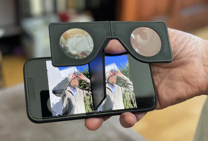 A person holding a smartphone with a 3D photo viewing application open, displaying a 3D image of a person taking the picture.